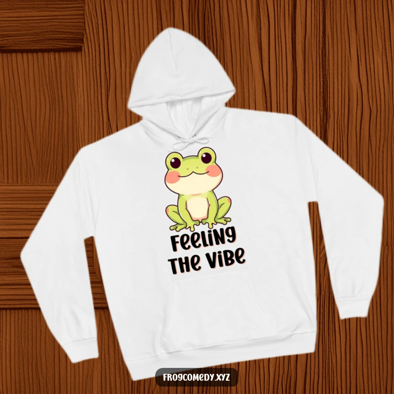 Funny hoodie featuring a rosy-cheeked frog doing a happy wiggle, perfect for cozy, joyful moments.