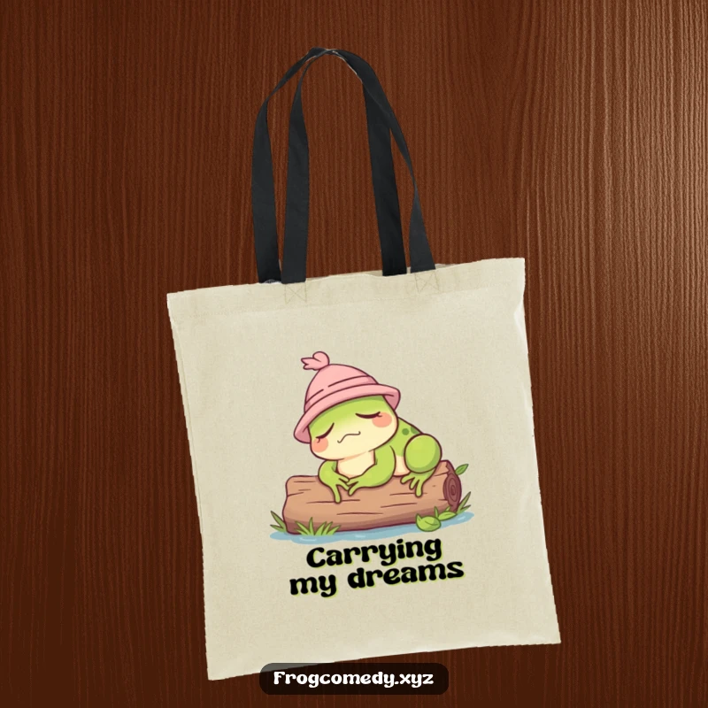 Funny tote bag showcasing a dozing frog adorned with a tiny hat, lounging on a log.